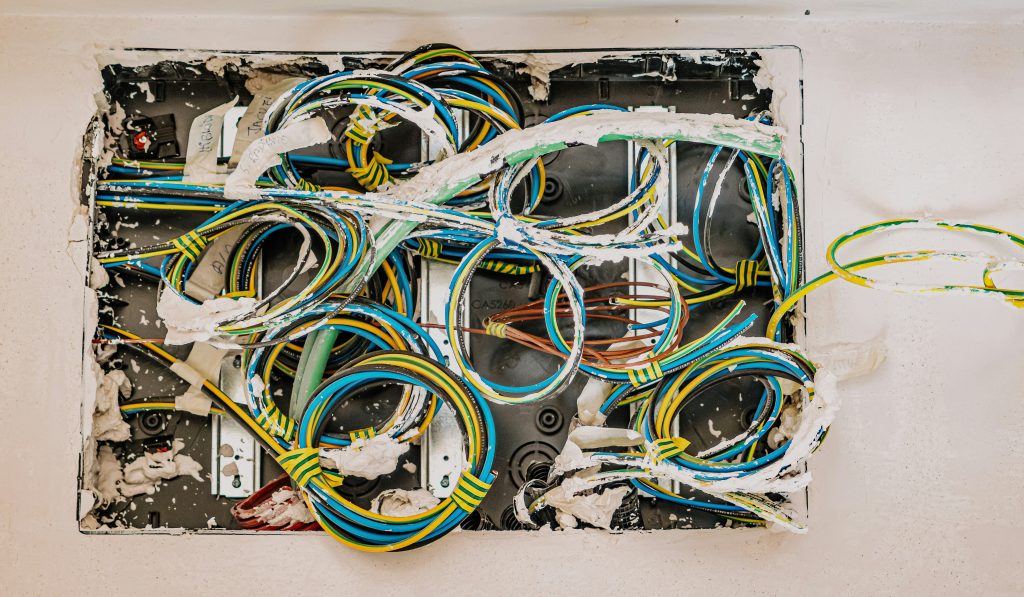 Messy wiring installation representing common hardware startup mistakes in manufacturing.