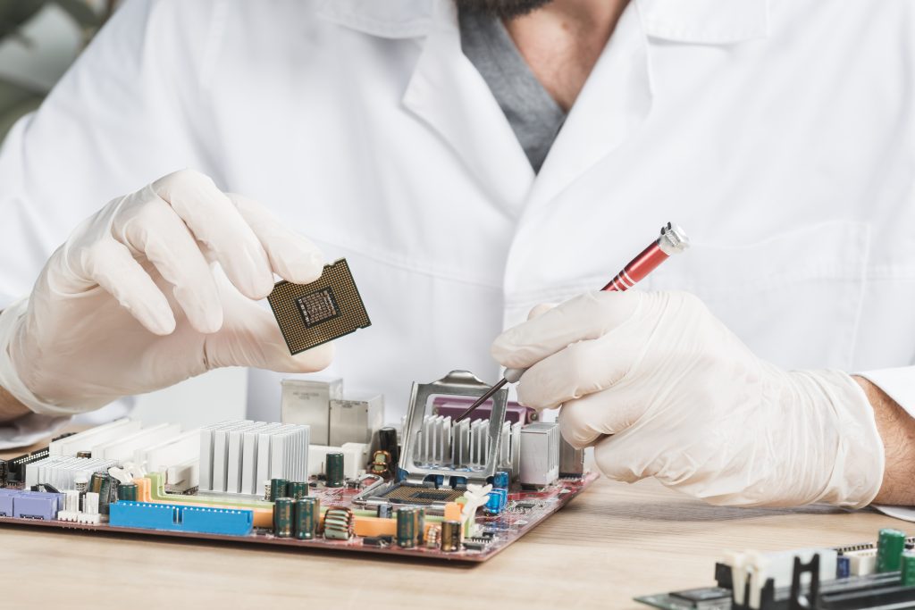 Engineer handling electronic components for BOM sourcing and manufacturing